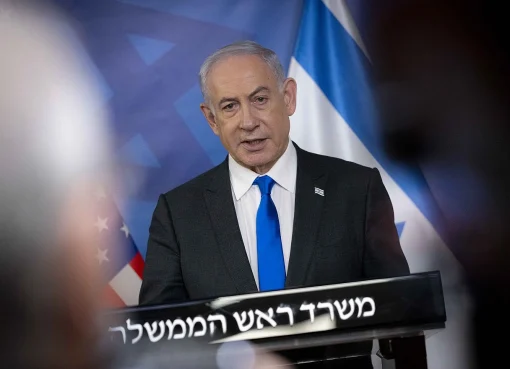An image of Benjamin Netanyahu, an Israeli politician known for his conservative security views and leadership during the Gaza war of 2014, wearing a suit and looking serious.