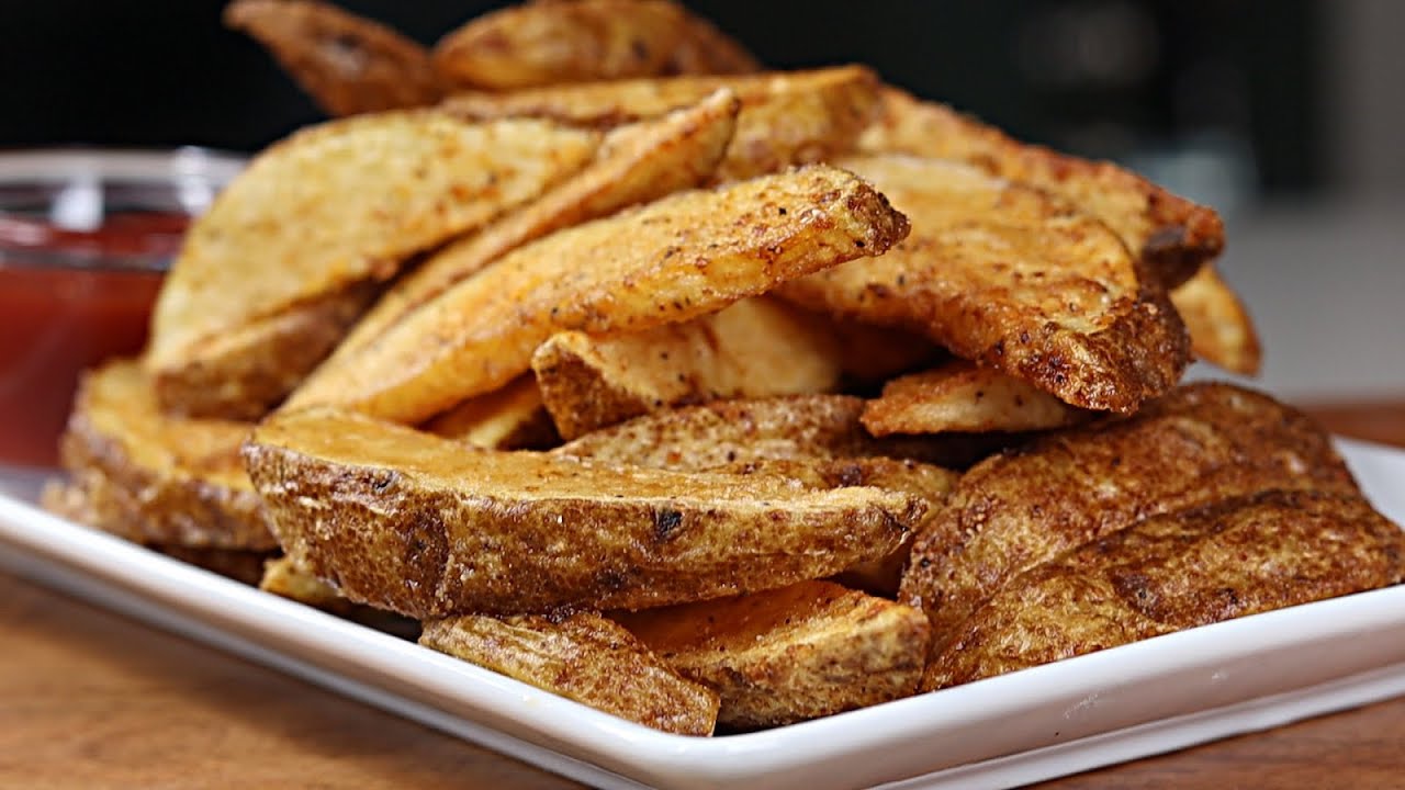 A vibrant display of crispy potato wedges topped with melted cheddar