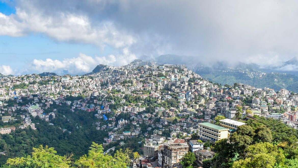 A scenic view of Durtlang Hills near Aizawl with misty mountains in the background