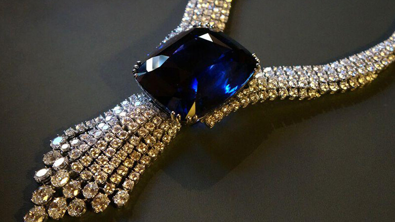 Close-up of the Blue Belle of Asia, a 392.52-carat blue sapphire necklace, showcasing its vivid blue color and intricate diamond setting.